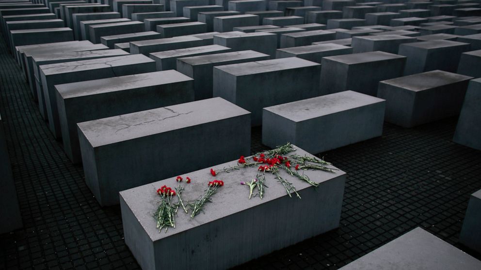 File- Flowers lie on a concrete slab of the Holocaust Memorial to mark the International Holocaust Remembrance Day and commemorating the 70th anniversary of the liberation of the Nazi Auschwitz death camp in Berlin, Jan. 27, 2015. Holocaust survivors