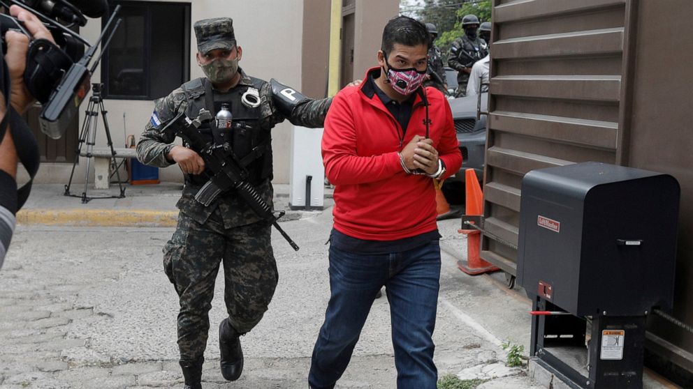 An alleged mastermind of the murder of Honduran environmental and Indigenous rights activist Berta Caceres, Roberto David Castillo is escorted by a police officer upon his arrival to the Supreme Court in Tegucigalpa, Honduras, Tuesday, April 6, 2021.