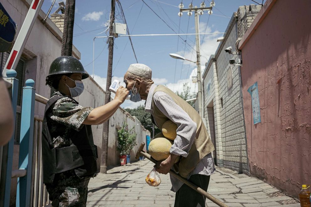 PHOTO: An old Uyghur is tested at a temperature checkpoint, June 29, 2020, in Kuqa, China. 