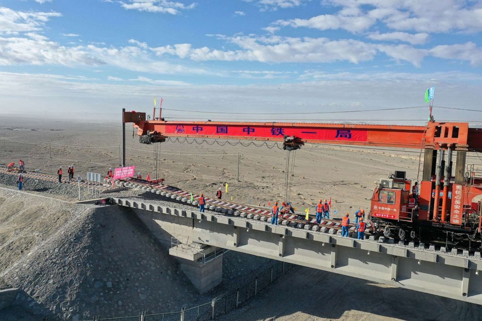 PHOTO: Workers lay tracks on the Golmud-Korla railway line near Altun Mountains in northwest China's Xinjiang Uygur Autonomous Region in China, July 21, 2020.