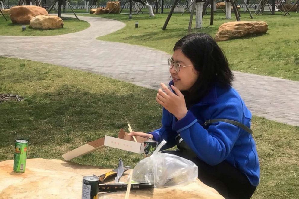 PHOTO: In this photo taken April 14, 2020 and released by Melanie Wang, Zhang Zhan eats a meal at a park during a visit to Wuhan in central China's Hubei province. 