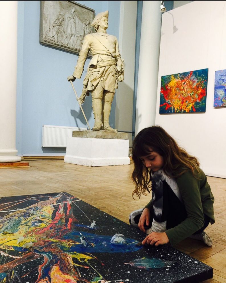 PHOTO: Aelita Andre pictured at the Russian Academy of Fine Arts Museum putting the final touches on her 'Music of the Infinite' exhibit.