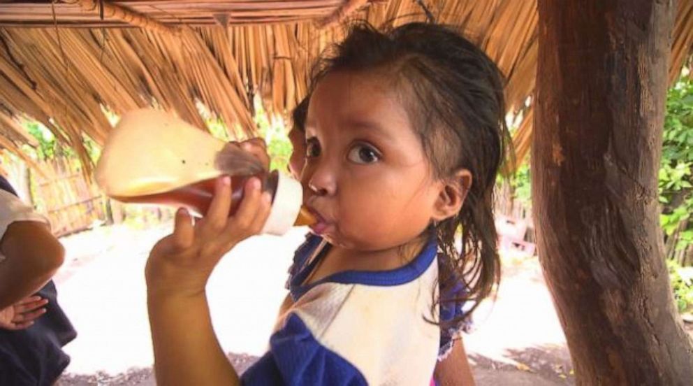 Anaeli drinking a bottle full of coffee to stave off hunger.