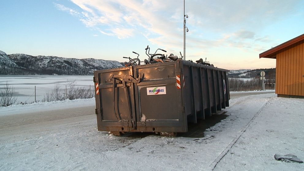 Once the refugees cross into Norway, they dump the bikes into containers and climb aboard buses waiting for them.