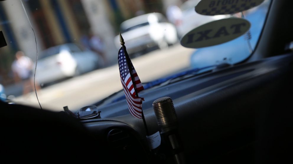 A miniature American flag decorates the inside of a taxi cab in Cuba on August 12, 2015. 