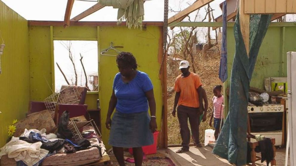 Verlyn Peter picked her way through the wreckage of her home in Dominica after Hurricane Maria.