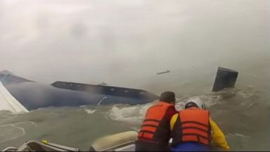 VIDEO: Passengers are seen clinging to the sinking ferry and being pulled from waters off the coast of South Korea.