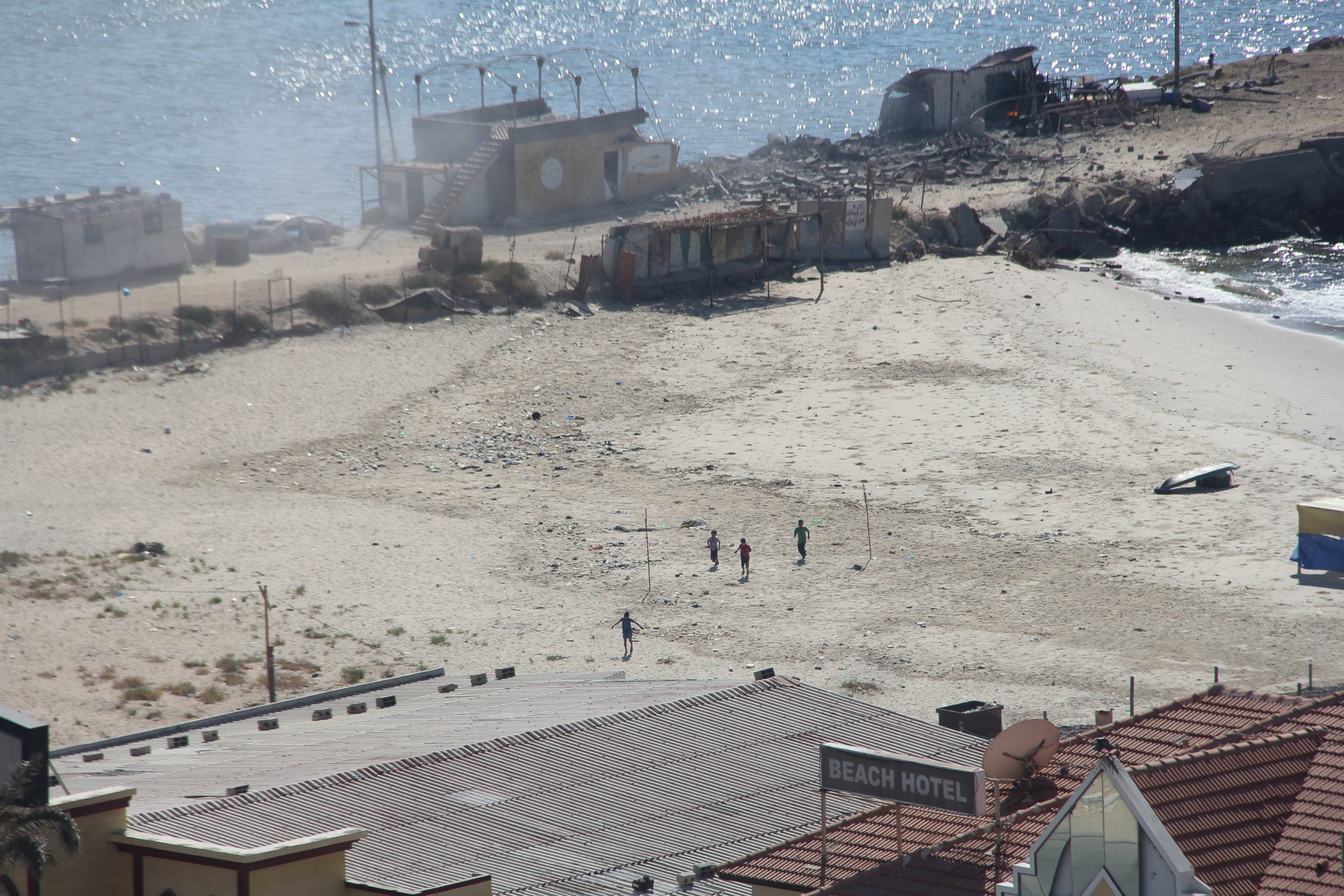 PHOTO: Four boys sprint across a beach in Gaza after the first blast from an Israeli shell.