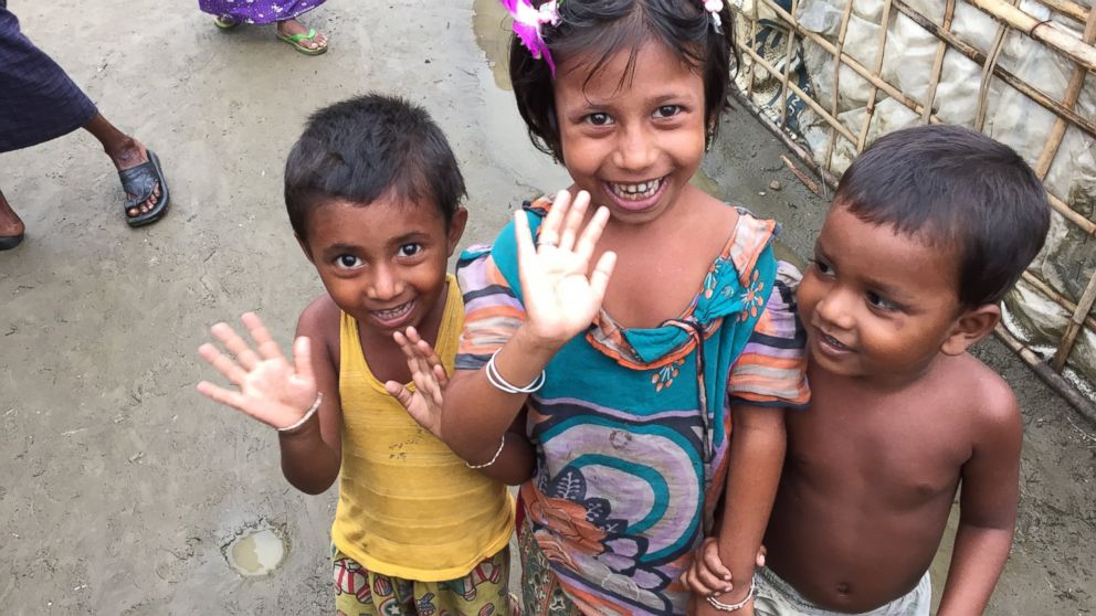 PHOTO: Young Rohingya children wave to the camera at a refugee camp outside of Sittwe, Myanmar.