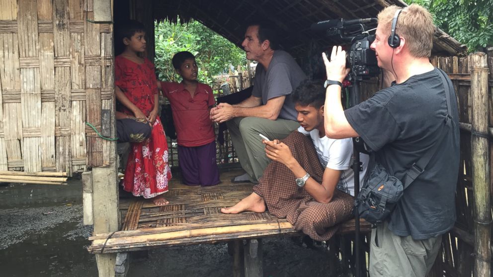 PHOTO: ABC News' Bob Woodruff and cameraman Sean Keane interview a woman and her children inside the refugee camps outside of Sittwe, Myanmar.
