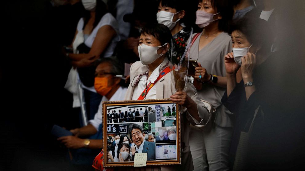 PHOTO: People wait for end of the funeral of late former Japanese Prime Minister Shinzo Abe outside Zojoji temple, in Tokyo, Japan, on July 12, 2022.