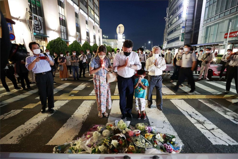 PHOTO: People pray near the location of the fatal shooting of former Japanese prime minister Shinzo Abe, 67, by a gunman during a House of Councillors election stump speech in Nara, western Japan on July 8, 2022.