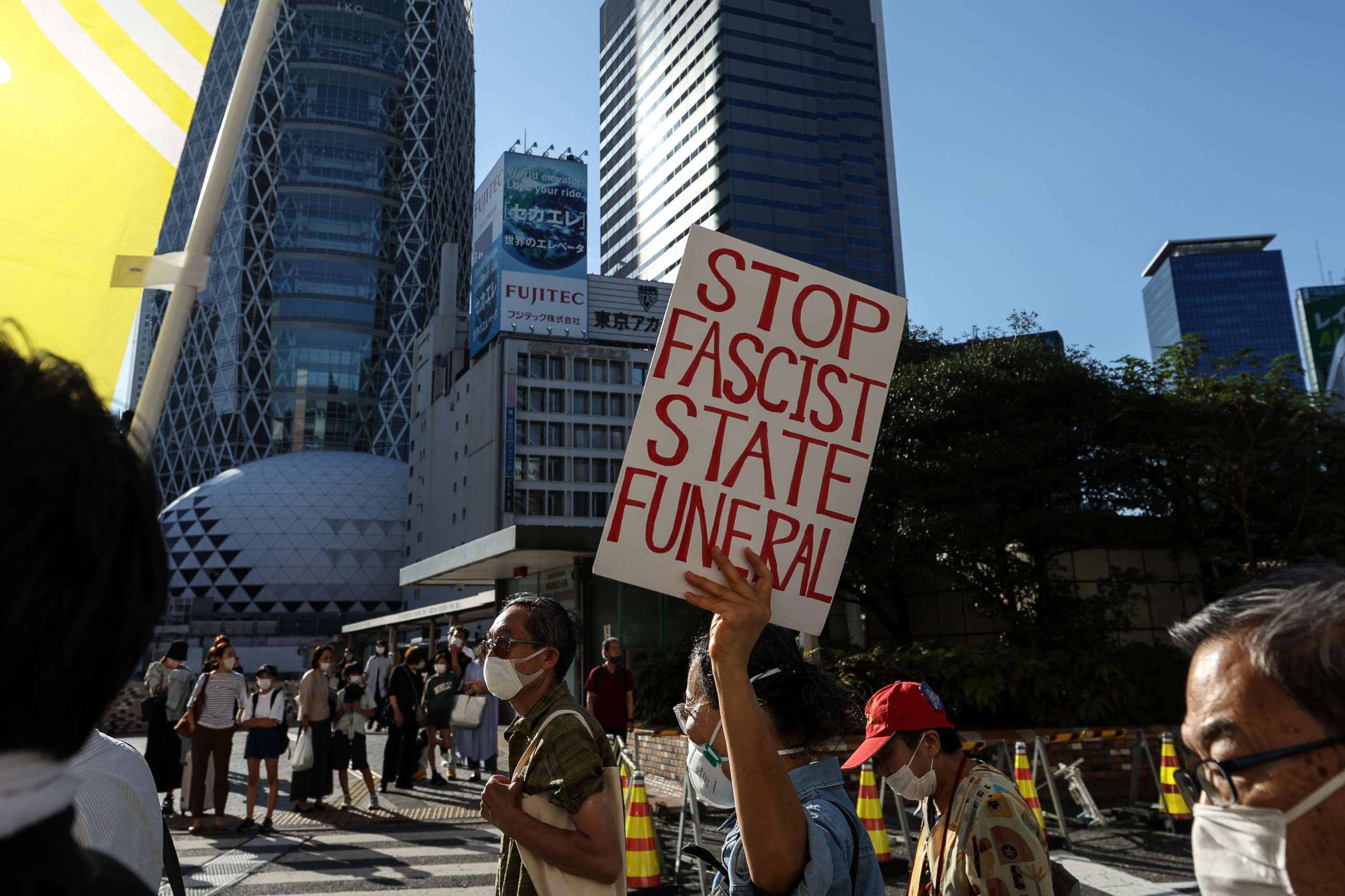 PHOTO: People hold signs and chant slogans during the march to protest against Shinzo Abe's State Funeral, on Sept. 25, 2022, in Tokyo, Japan