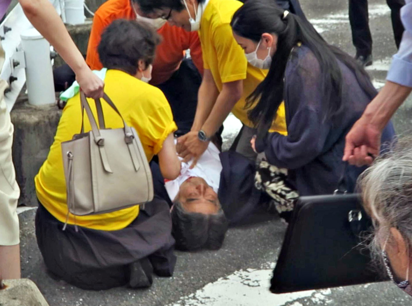 PHOTO: Former Japanese Prime Minister Shinzo Abe lies on the ground after being shot from behind by a man in Nara, western Japan, July 8, 2022. Abe was pronounced dead at a local hospital.