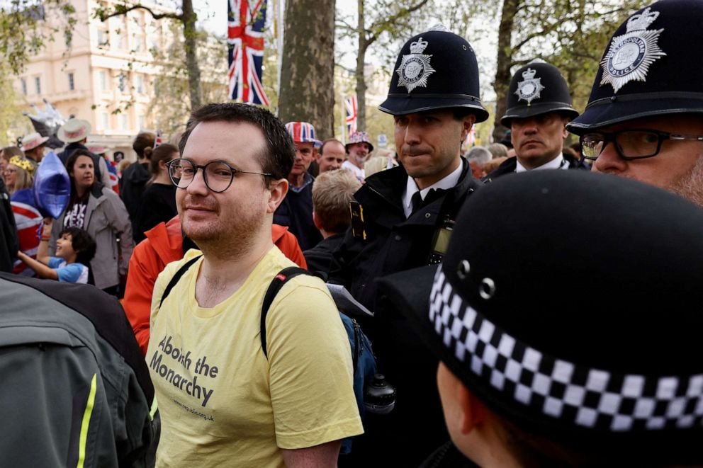 PHOTO: Police members talk to an Abolish The Monarchy protester on The Mall, ahead of the coronation of Britain's King Charles and Queen Camilla, in London, May 6, 2023.