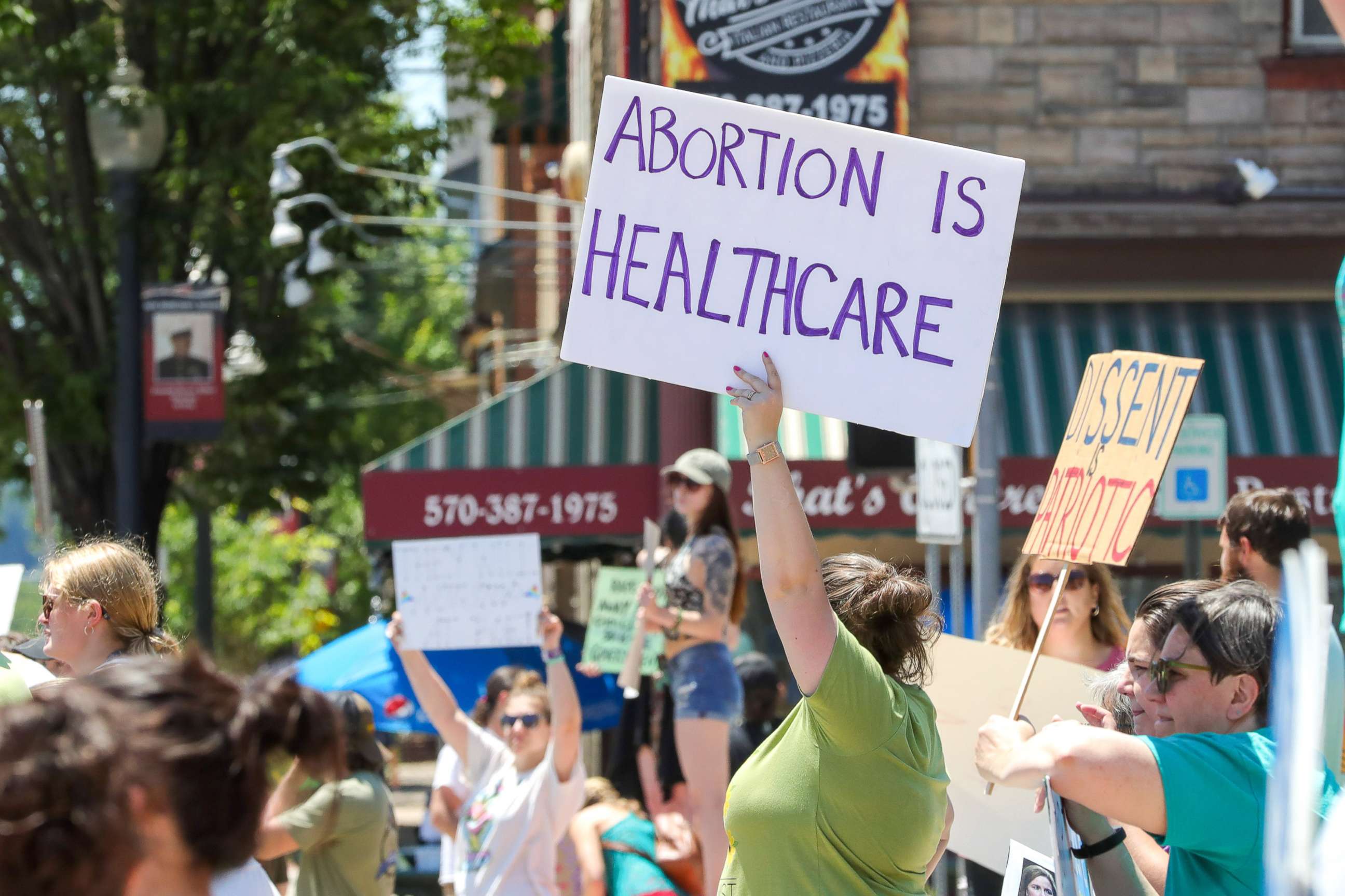 PHOTO: A woman holds a placard saying "abortion is healthcare" during an abortion rights rally organized in response to the US Supreme Court's decision to overturn Roe v. Wade, in Bloomsburg, Pa., July 3, 2022.