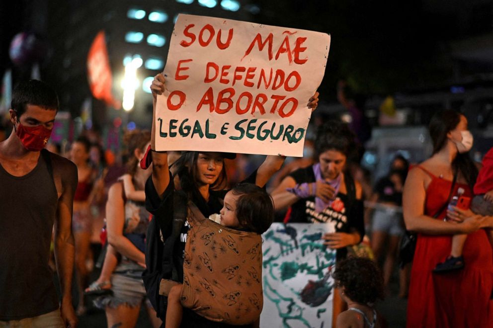 PHOTO: A woman holds a sign that says "Sou Mae e Defendo o Aborto Legal e Seguro" (" I am a mother and I suport legal and safe abortions") during a demonstration to commemorate the International Womens Day in Rio de Janeiro, March 8, 2022.  
