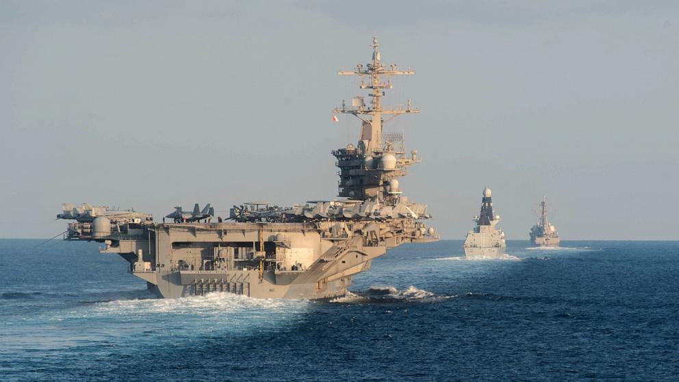 PHOTO: The aircraft carrier USS Abraham Lincoln (L), the air-defense destroyer HMS Defender and the guided-missile destroyer USS Farragut transit the Strait of Hormuz on Nov. 19, 2019. The U.S. will bolster its military presence in the Middle East.