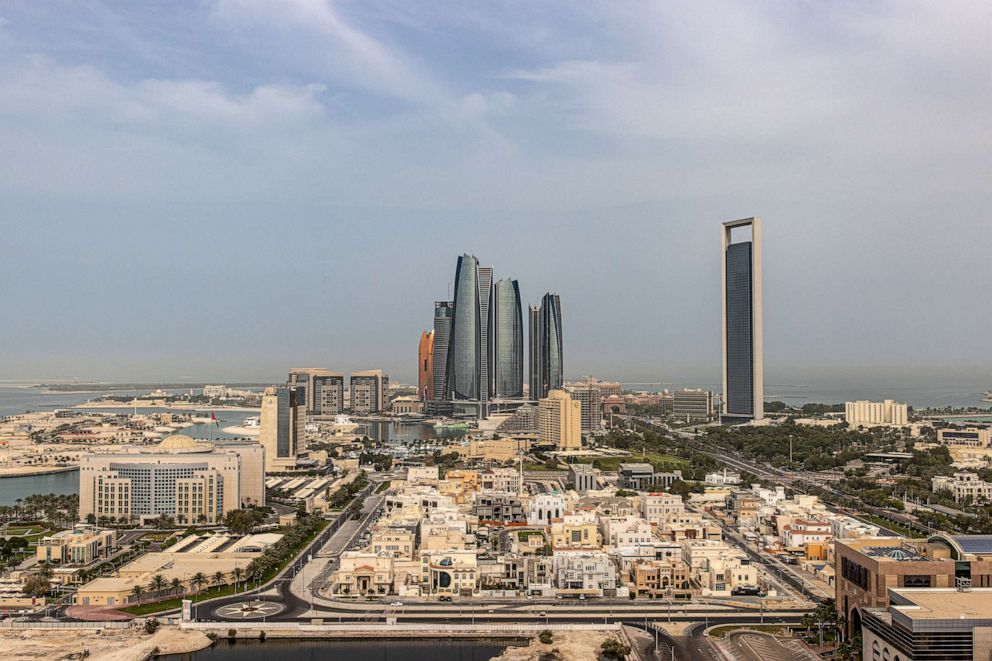PHOTO: The headquarters of the Abu Dhabi National Oil Co. (ADNOC), right, and Etihad Towers, center, surrounded by residential and commercial properties in Abu Dhabi, United Arab Emirates, April 10, 2022.