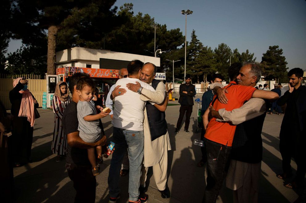PHOTO: Afghans and travelers pass through checkpoints at the Hamid Karzai International Airport in Kabul, ahead of the Taliban's arrival, Aug. 15, 2021.