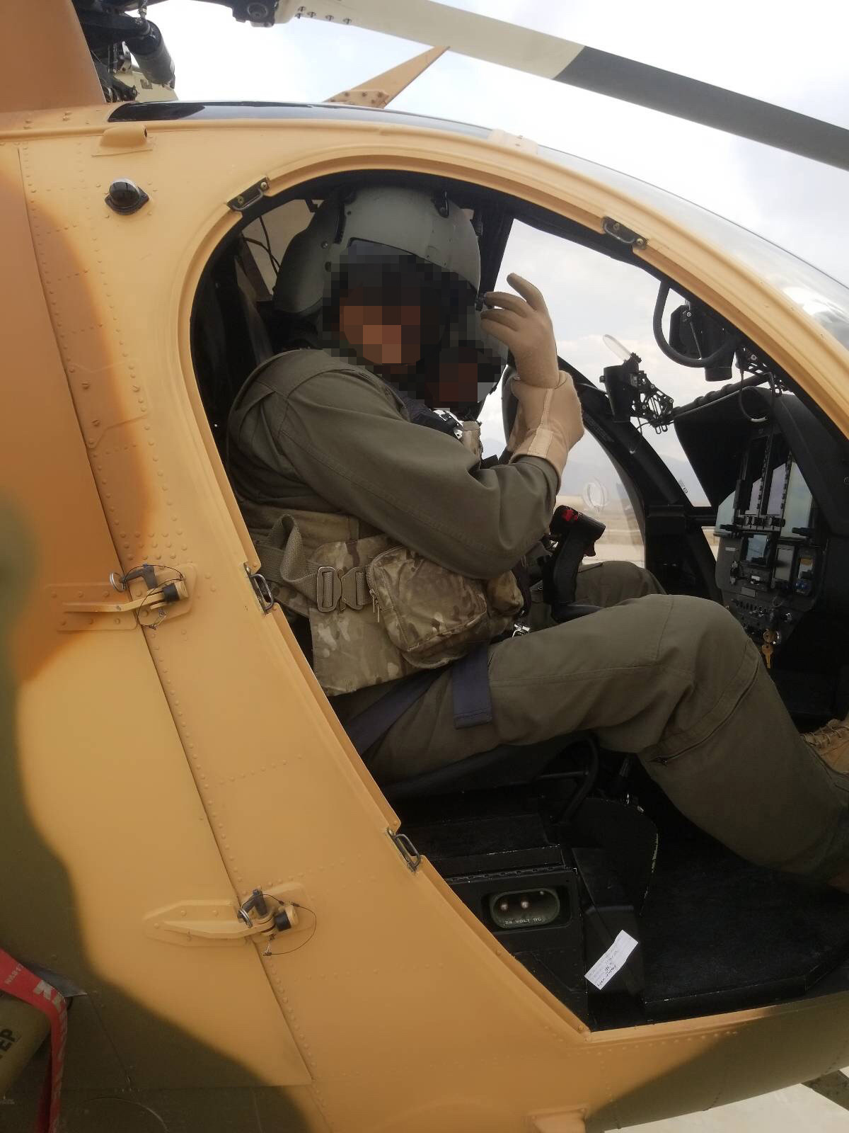 PHOTO: An Afghan pilot sits in his MD530F helicopter.