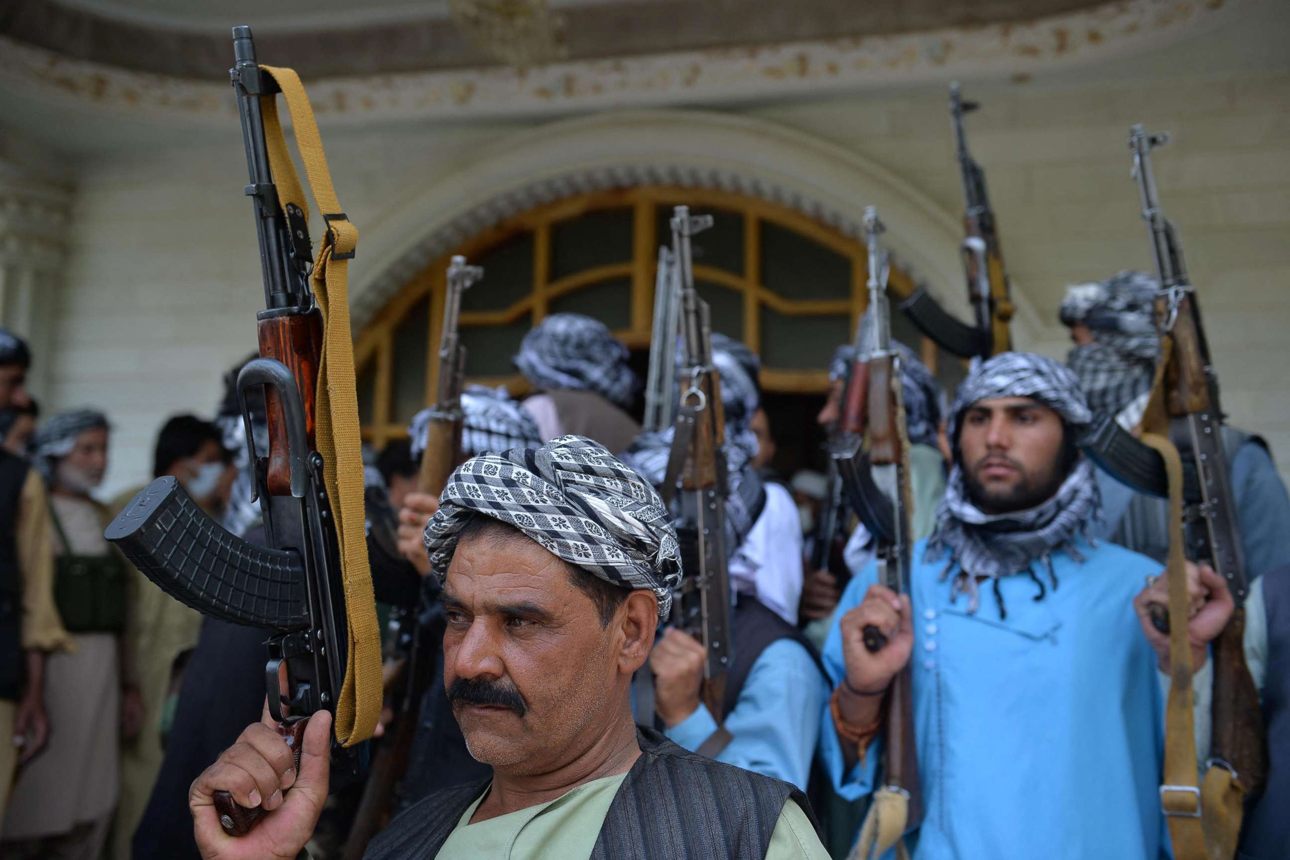 PHOTO: Afghan militia gather with their weapons to support Afghanistan security forces against the Taliban, in Afghan warlord and former Mujahideen Ismail Khan's house in Herat on July 9, 2021. 