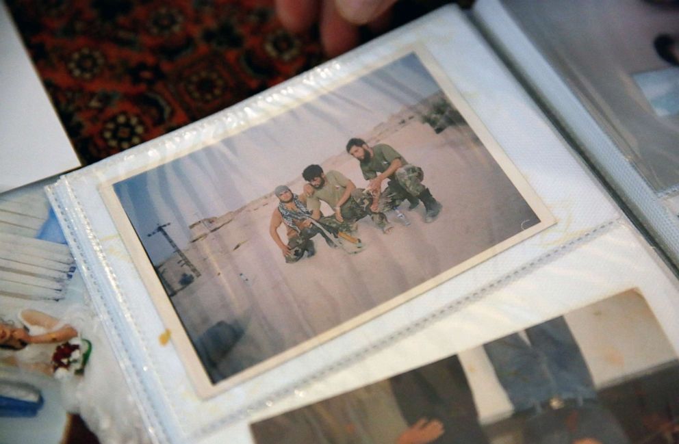 PHOTO: A photo of Najib Mohammadi, right, and two of his military team members is seen in a family photo album at Mohammadi's home in Sacramento, Calif., Sept. 12, 2021.