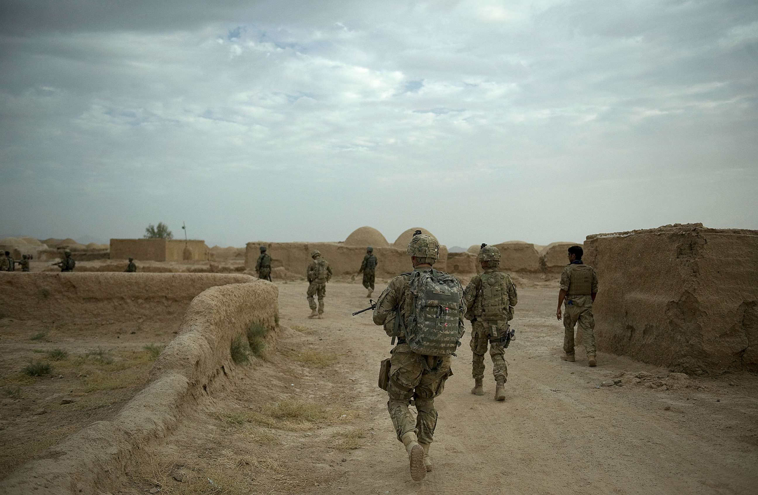 PHOTO: A joint patrol between soldiers from the 1st Platoon, 1-64 Armored Batallion of the U.S. Army,  operating under NATO command, walks through Morghan-Khecha village in Daman district, Kandahar Province, Afghanistan, Sept. 8, 2012. 