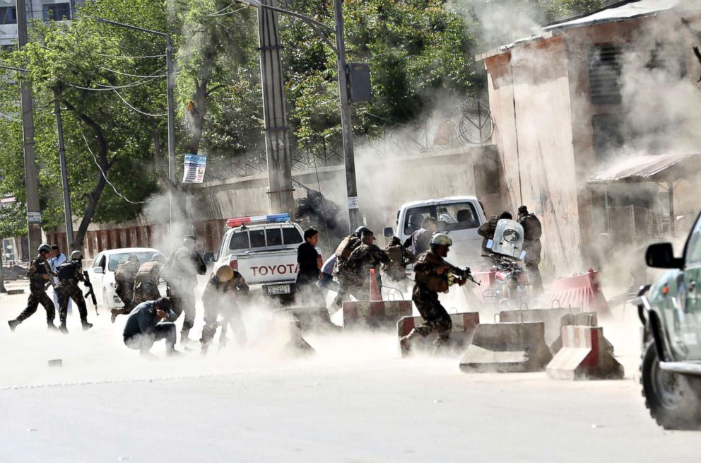 PHOTO: Security forces run from the site of a suicide attack after the second explosion in Kabul, April 30, 2018. A coordinated double suicide bombing hit central Kabul.