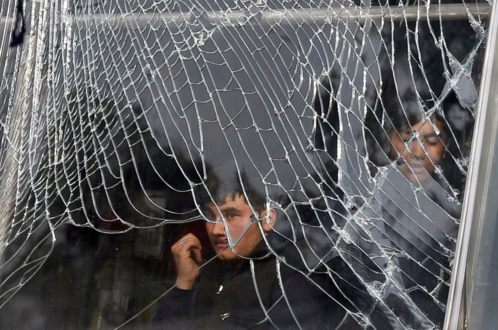 PHOTO: A shopkeeper looks out behind broken glass of his shop, near the site of a car bomb attack in Kabul, Afghanistan, Jan. 27, 2018.