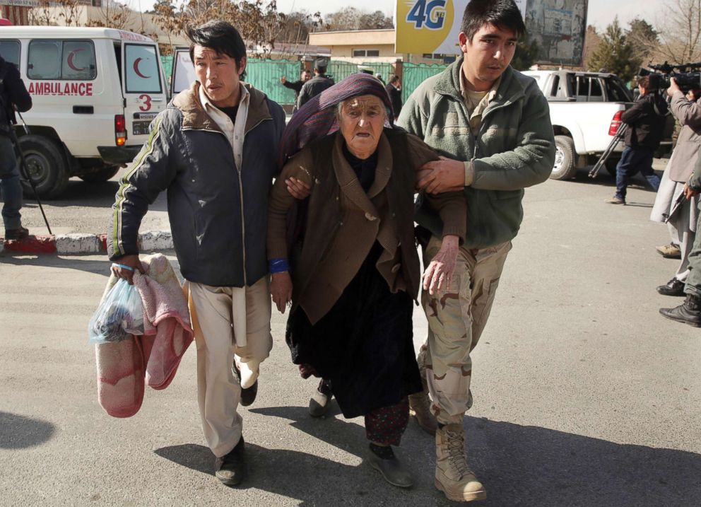 PHOTO: An wounded elderly woman is assisted at the site of a deadly suicide attack in the center of Kabul, Afghanistan, Jan. 27, 2018.