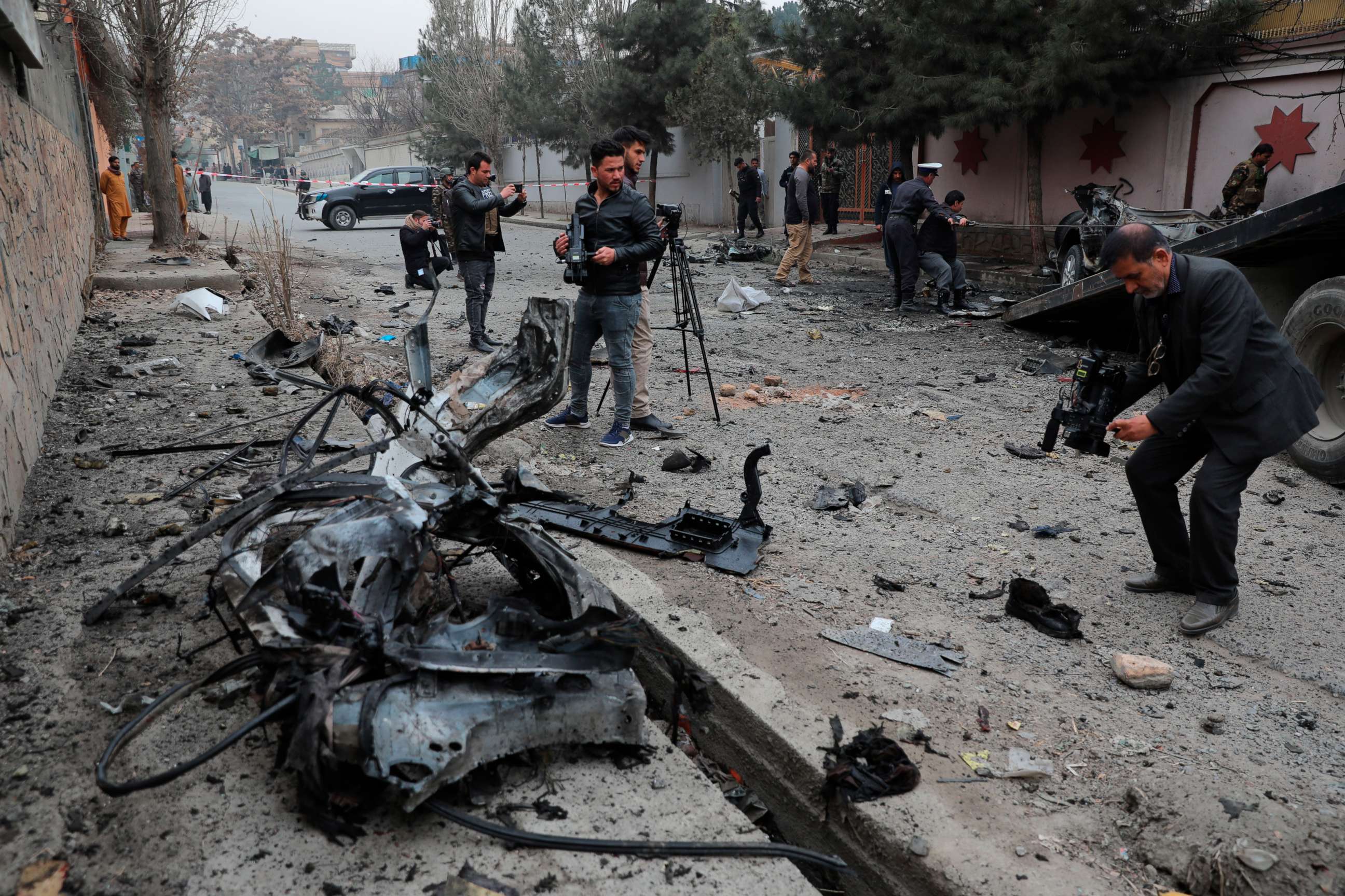 PHOTO: Afghan journalists film at the site of a bombing attack in Kabul, Afghanistan, Feb. 20, 2021.
