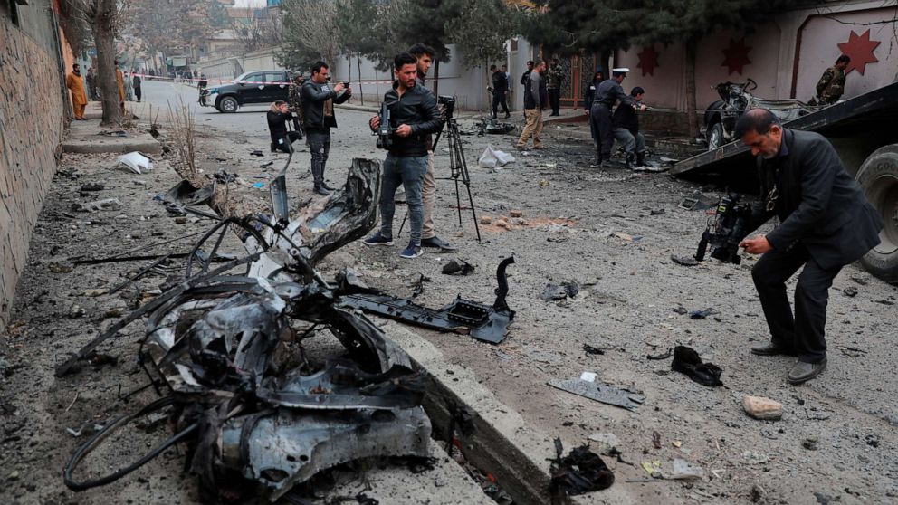 PHOTO: Afghan journalists film at the site of a bombing attack in Kabul, Afghanistan, Feb. 20, 2021.
