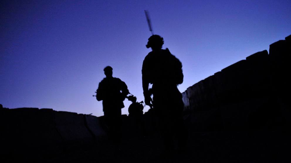U.S. troops under Afghanistan's International Security Assistance Force, and Afghan National Army soldiers conduct a joint security dawn patrol in the center of Kandalay village, as a fire fight against Taliban insurgents erupts in the outskirts of the village, in Kandahar, Afghanistan, Aug. 4, 2011.