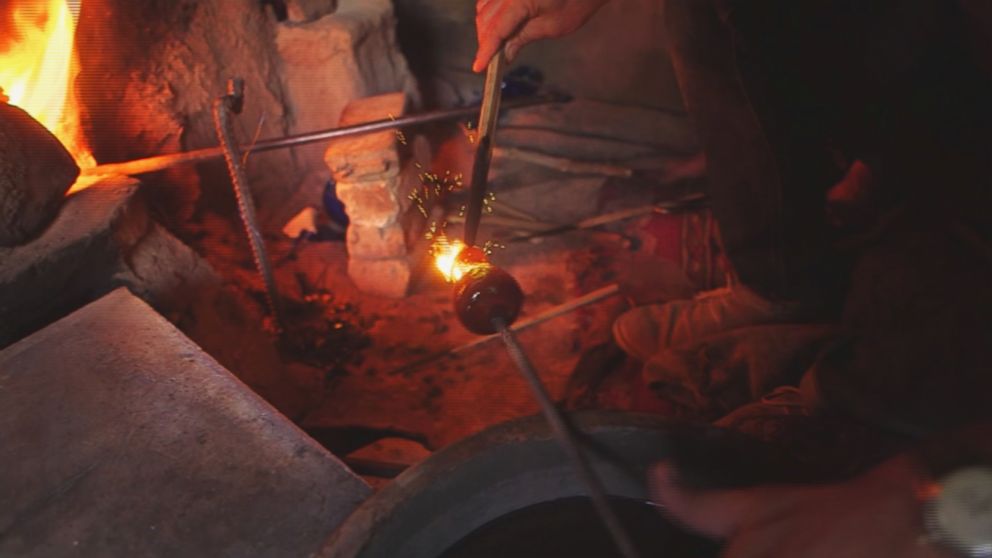 PHOTO: A glassblower practices his craft in the western Afghanistan city of Herat.