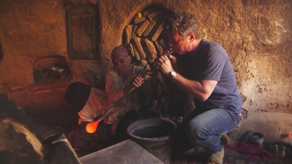 PHOTO: A glassblower gives ABC News' Ian Pannell a try at blowing glass in a workshop in the western Afghanistan city of Herat.