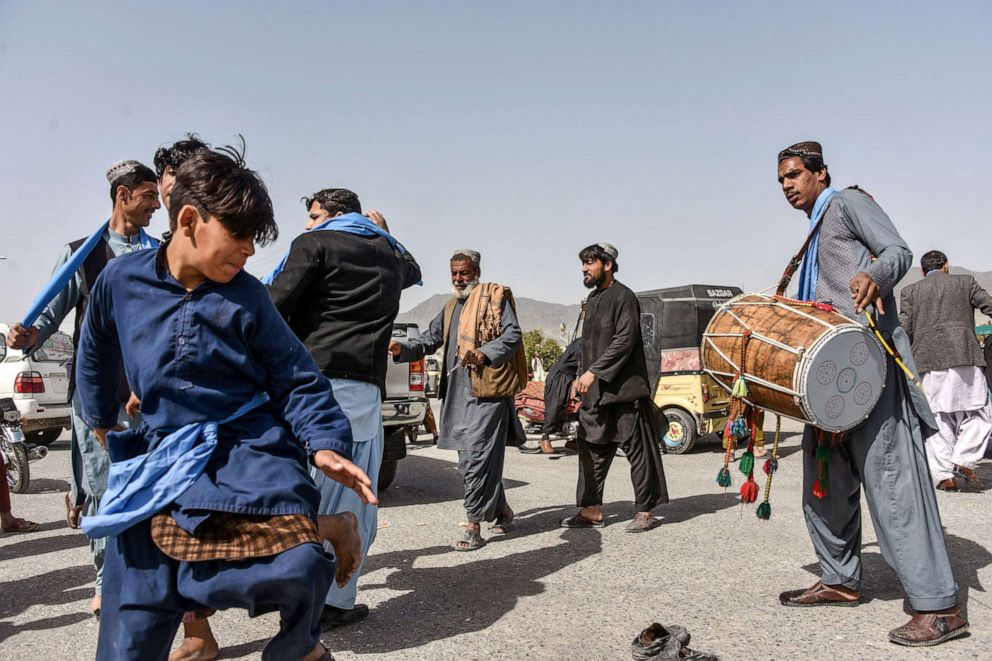 PHOTO: People dance as they celebrate the first day of "reduction in violence" agreed between the Taliban, US and Afghan forces in Kandahar province, Feb. 22, 2020. 
