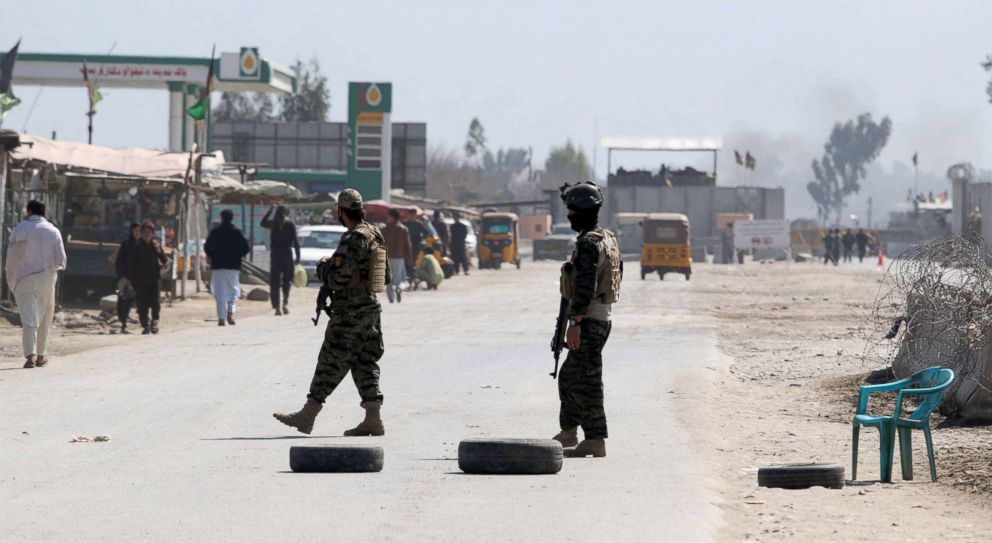 PHOTO: Afghan security officials stand guard on the road leading to the scene of a gun and suicide bomb attack in Jalalabad, Afghanistan, March 6, 2019.