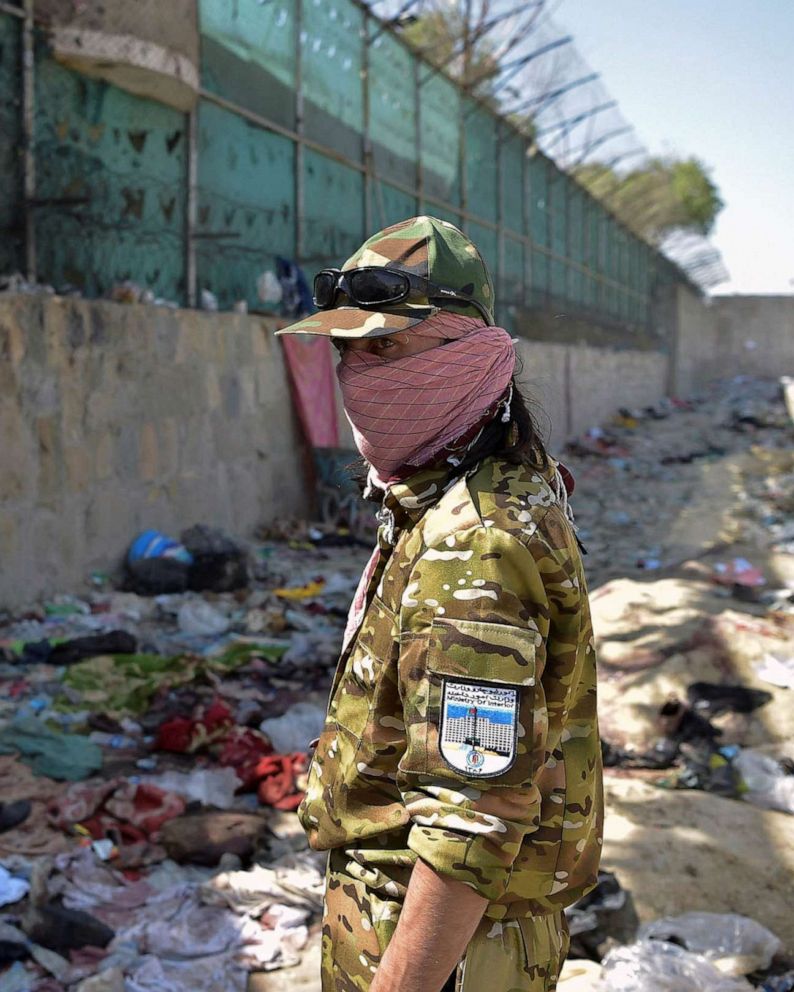PHOTO: FILE - A Taliban fighter stands guard at the site of the August 26 twin suicide bombs, which killed scores of people including 13 US troops, at Kabul airport, Aug. 27, 2021.