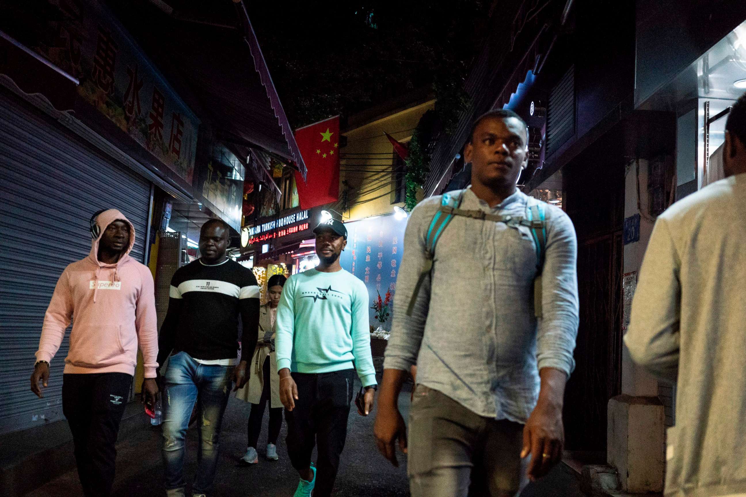 PHOTO: FILE PHOTO: People walk in the "Little Africa" district in Guangzhou, the capital of southern China's Guangdong province, March 1, 2018.