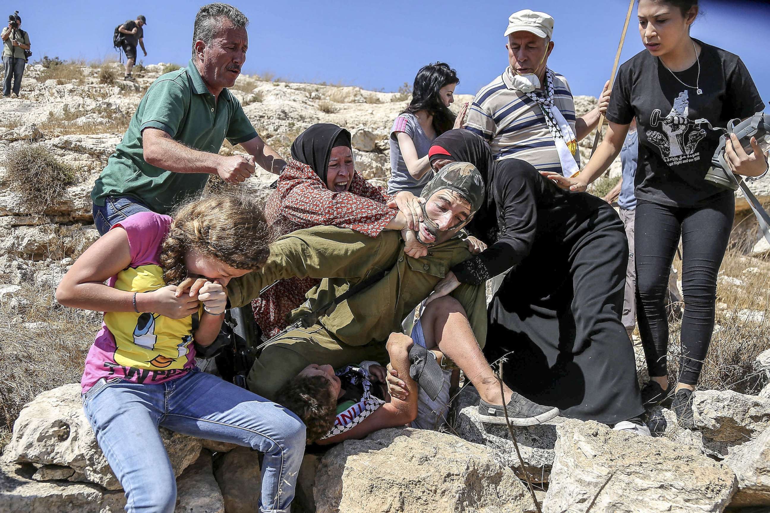 PHOTO: Ahed Tamimi reacts to an Israeli soldier attempts to arrest a Palestinian kid during the clashes following a protest against expropriation of Palestinian land in the West Bank, Aug.28, 2015.