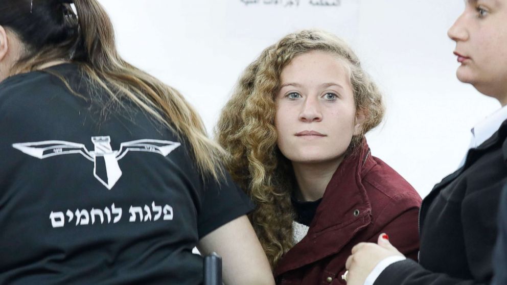 PHOTO: 17 year old Palestinian Ahed Tamimi (C), a campaigner against Israel's occupation, appears at a military court at the Israeli-run Ofer prison in the West Bank village of Betunia, Dec. 20, 2017. 