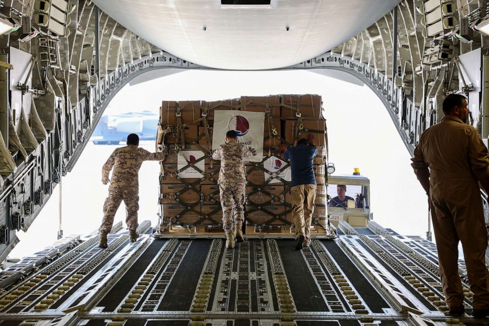 PHOTO: Qatari Amiri Air Force crew load food and medical aid to their cargo plane from the Qatar Fund for Development headed to Egypt for Gaza, at Al Udeid Air Base, Doha, Qatar, Oct. 16, 2023.