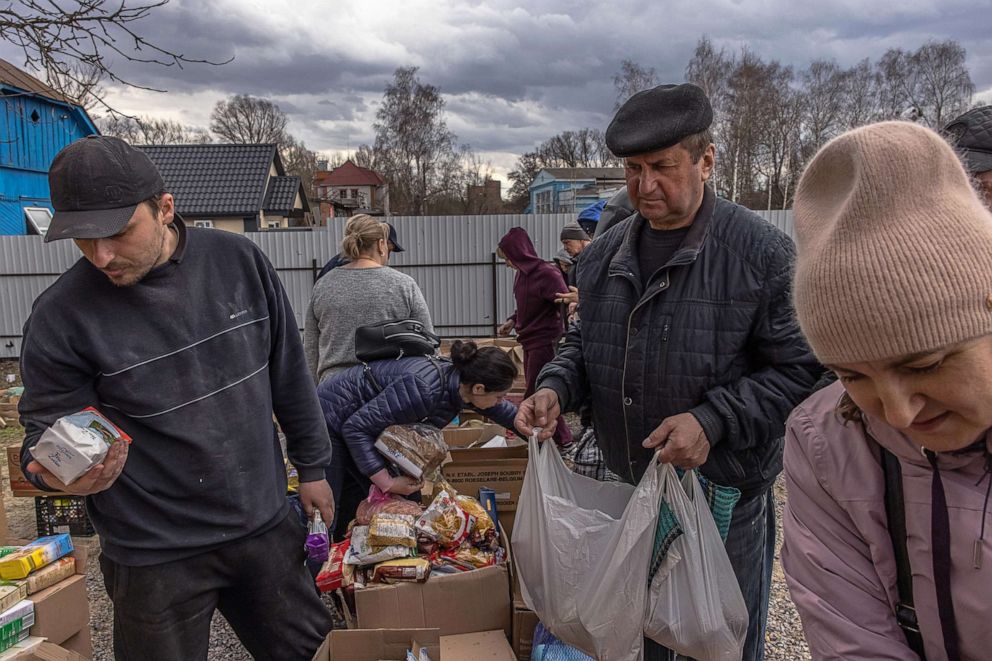 PHOTO: Local residents receive a humanitarian aid, after the Ukrainian army recaptured the town of Trostyanets, in Sumy region, Ukraine, March 29, 2022.