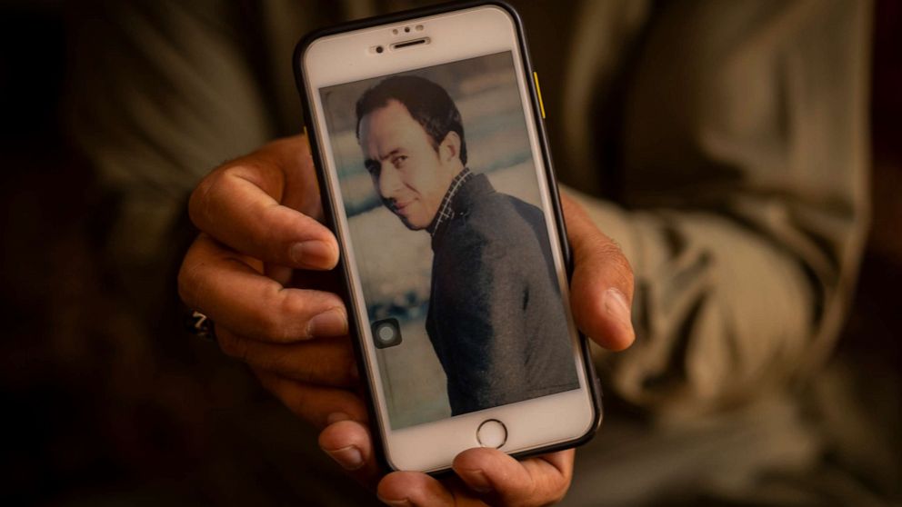 PHOTO: In this Sept. 13, 2021, file photo, Emal Ahmadi holds a picture of his slain brother Zemerai Ahmadi at the family house in Kabul, Afghanistan.
