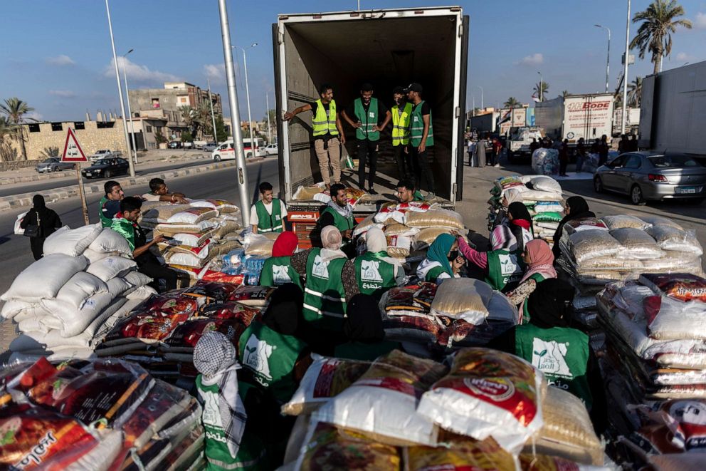 PHOTO: Volunteers load food and supplies onto trucks in an aid convoy for Gaza on Oct. 16, 2023 in North Sinai, Egypt.