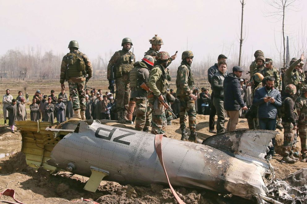 PHOTO: Indian soldiers stand next to the wreckage of an Indian Air Force helicopter after it crashed in Budgam district in Kashmir Feb. 27, 2019.