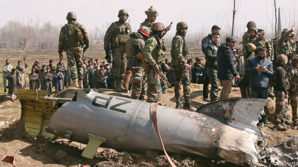 PHOTO: Indian soldiers stand next to the wreckage of an Indian Air Force helicopter after it crashed in Budgam district in Kashmir Feb. 27, 2019.