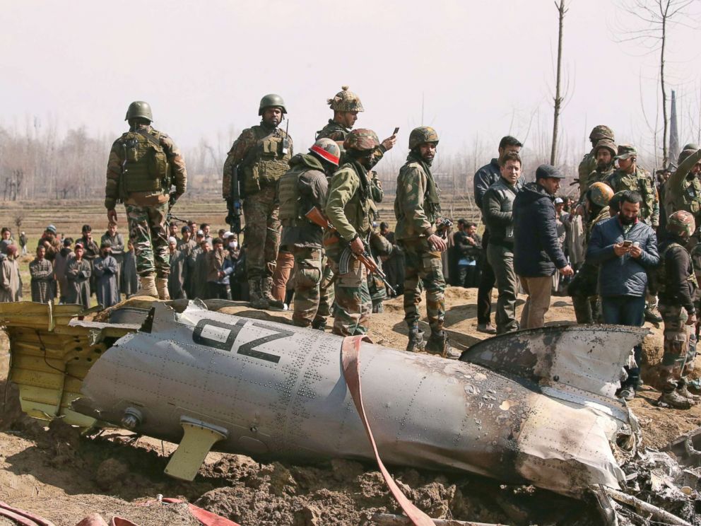 PHOTO: Indian soldiers stand next to the wreckage of an Indian Air Force helicopter after it crashed in Budgam district in Kashmir Feb. 27, 2019.