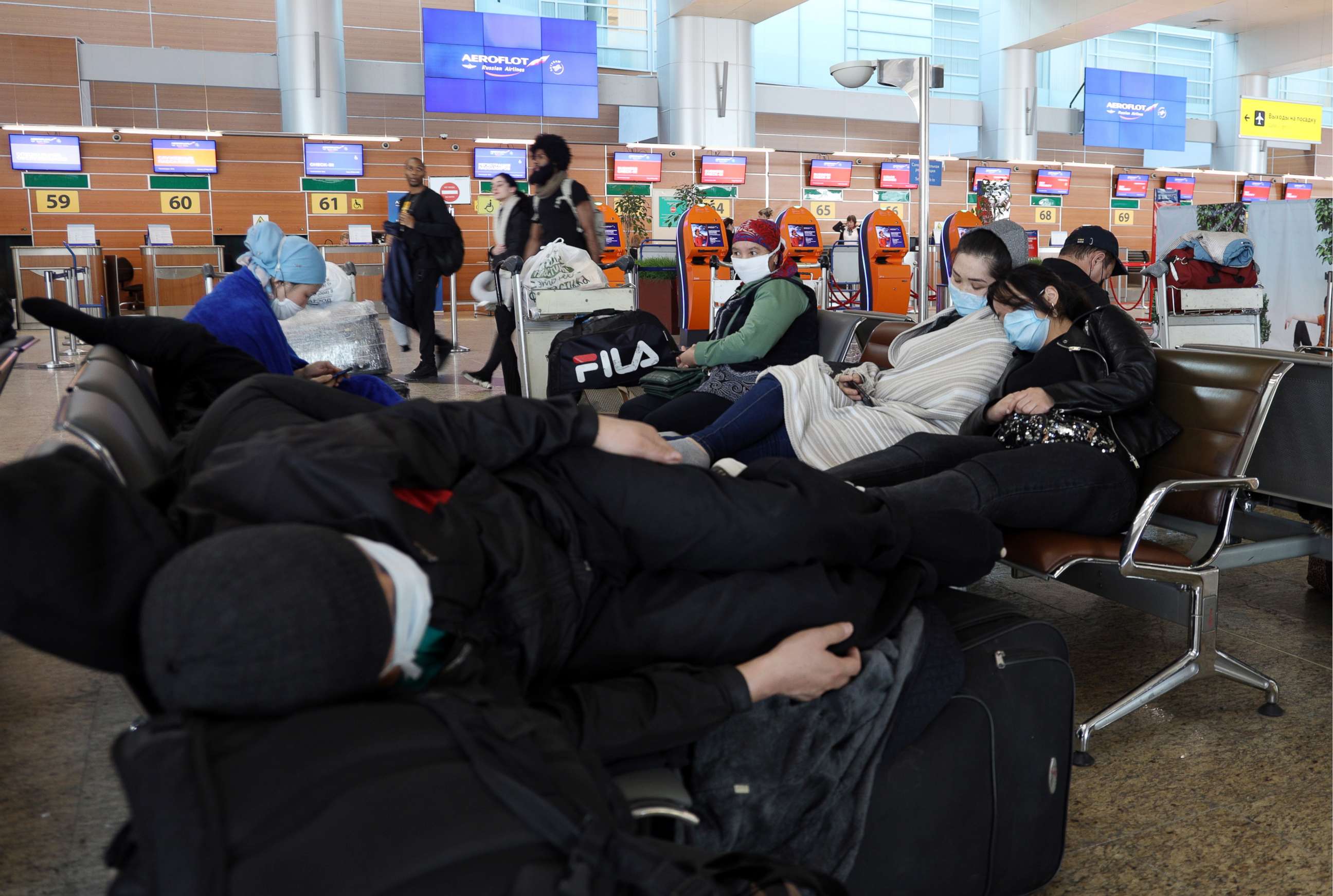 PHOTO: Passengers at Sheremetyevo International Airport sit on the first day of an international flight ban ordered by the government amid the ongoing COVID-19 pandemic and effective since March 27.